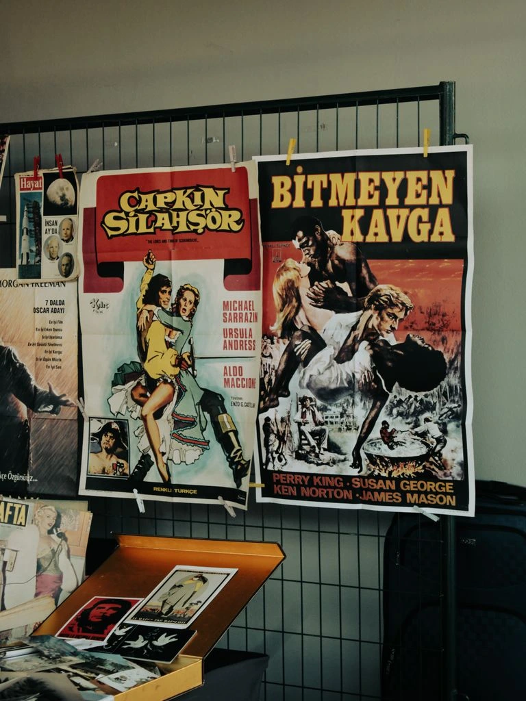 Poster still of an exposed film strip curling down a teal ground.
